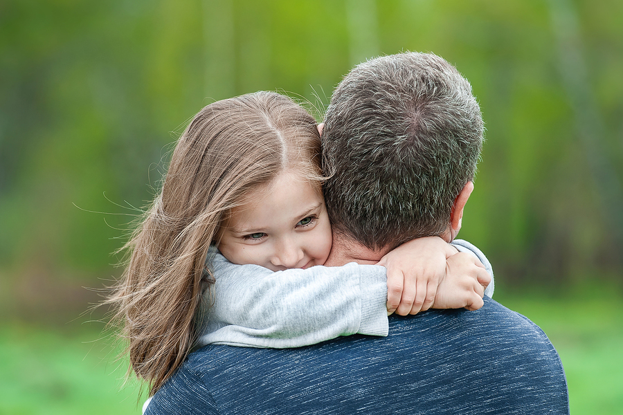 Portrait Of Girl Held In Father Arms.
